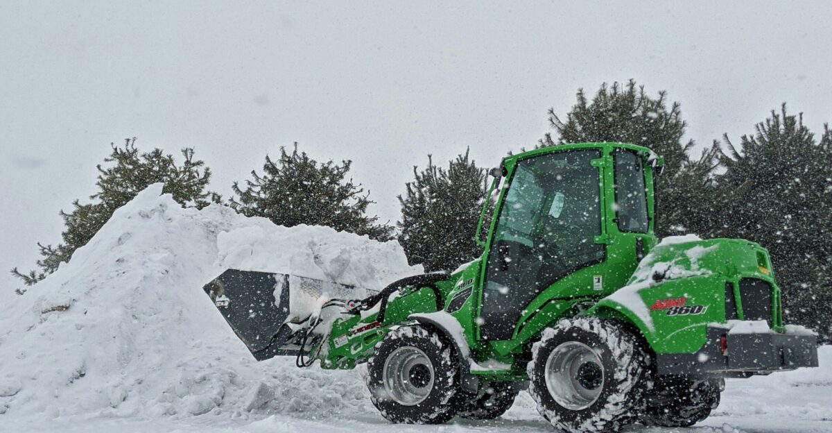 green and black atv on snow covered ground