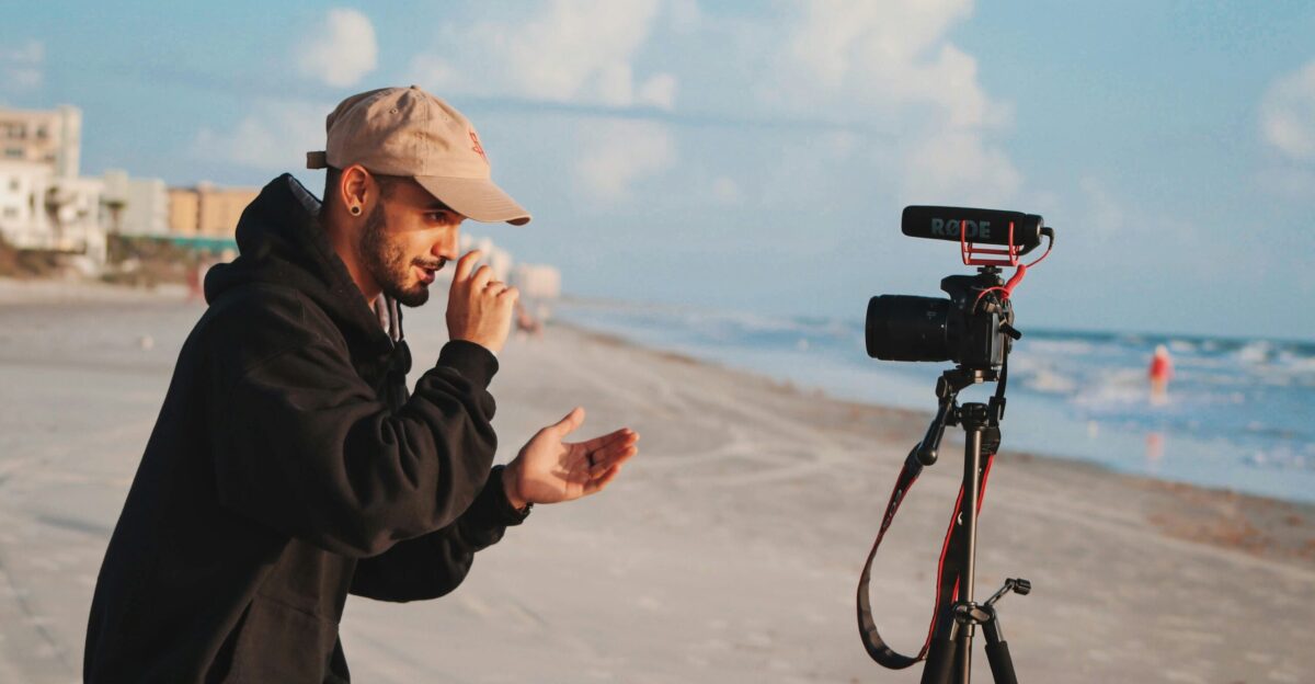 man in black jacket holding camera during daytime