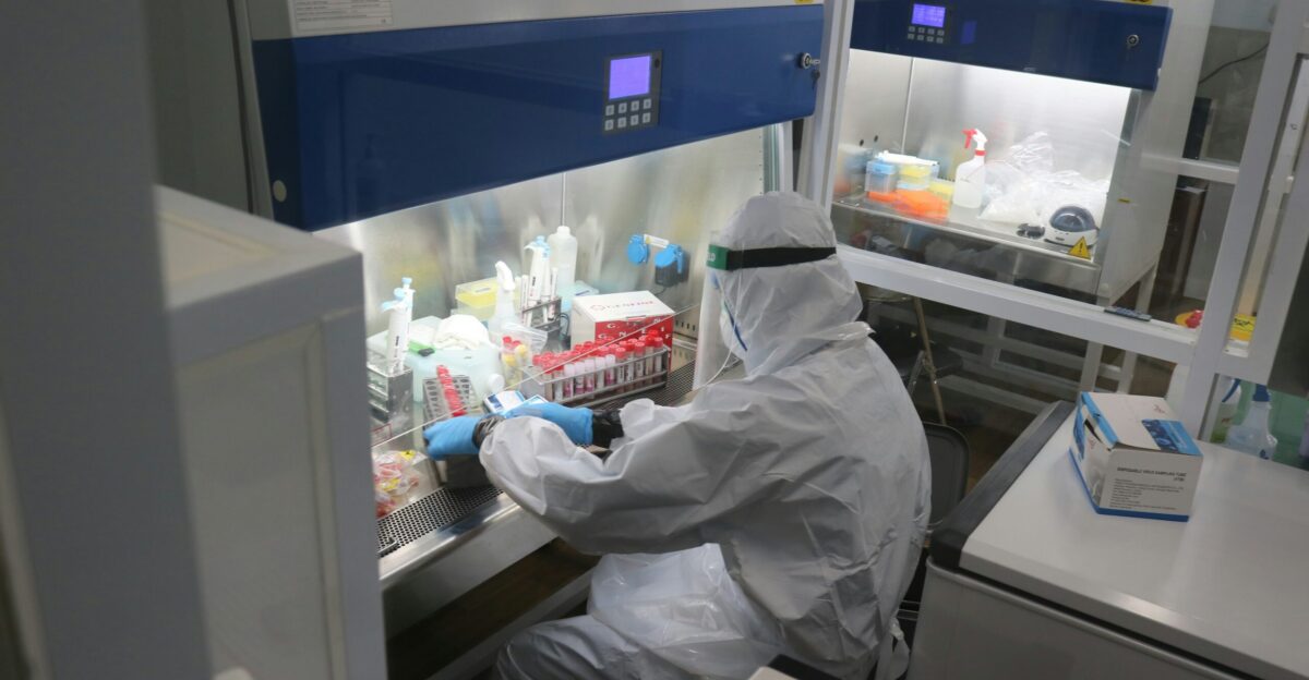 person in white dress shirt and gray hijab