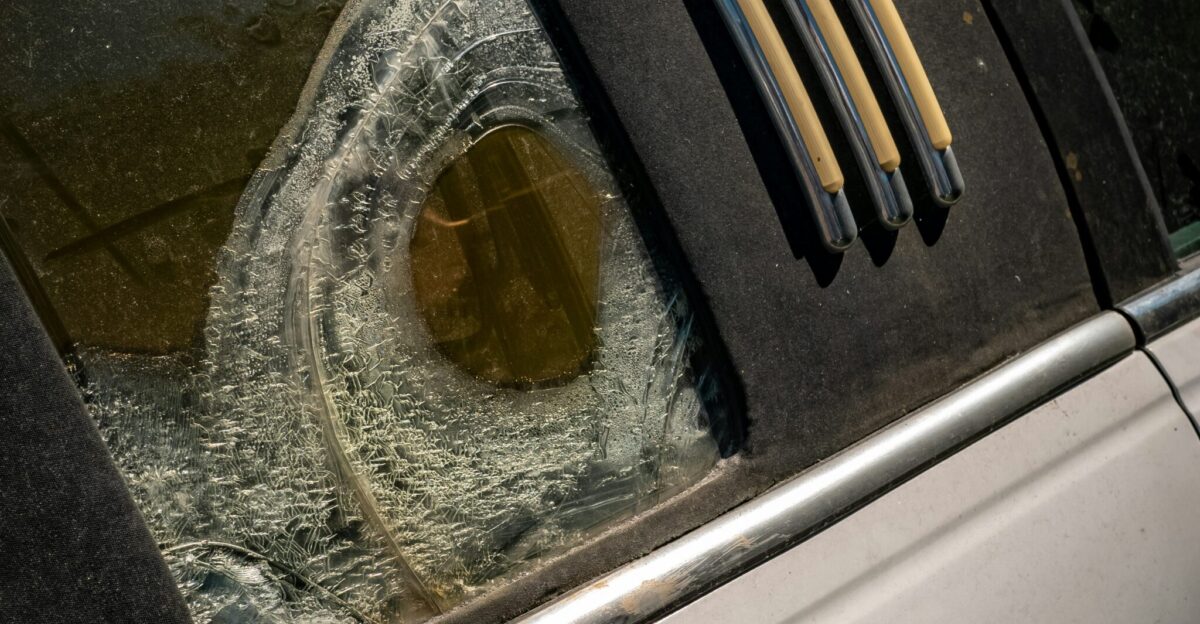 a broken windshield of a car with a broken window