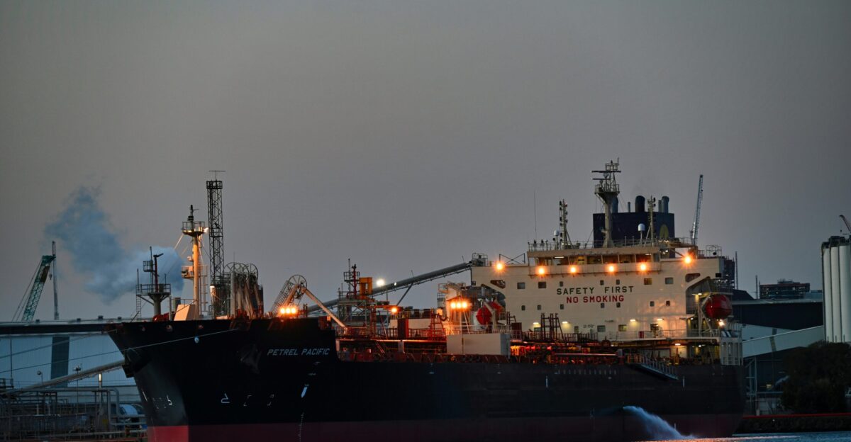a large cargo ship in a harbor at night