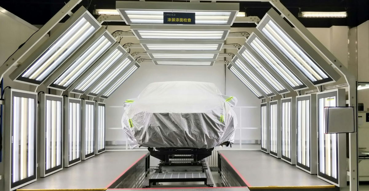 a car covered with a tarp is parked in a garage