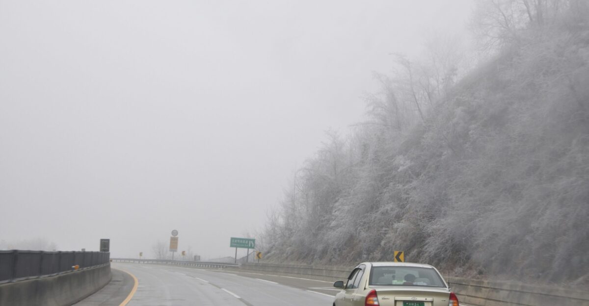 a car driving on a foggy highway