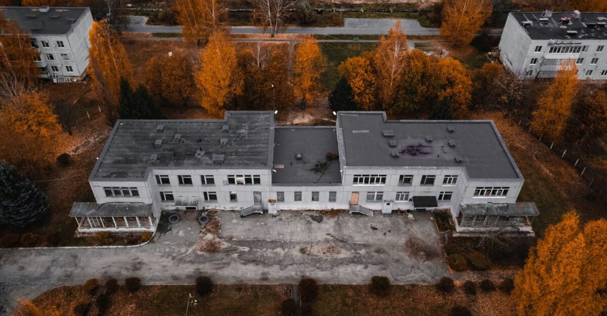 an aerial view of a house surrounded by trees