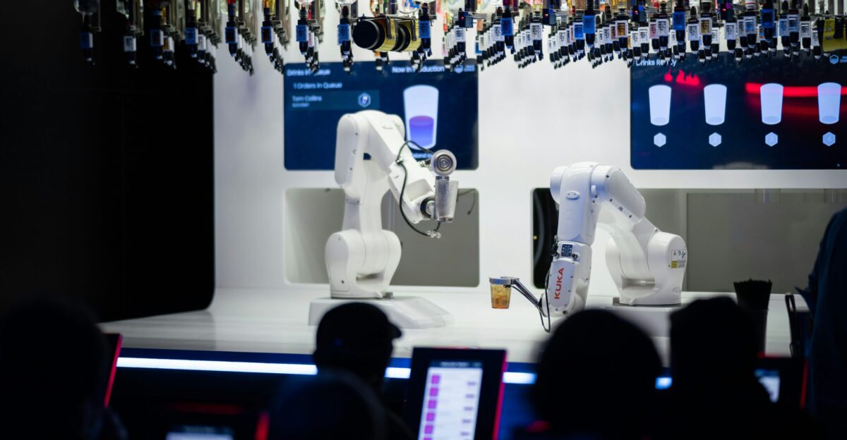 a group of people sitting in front of laptops