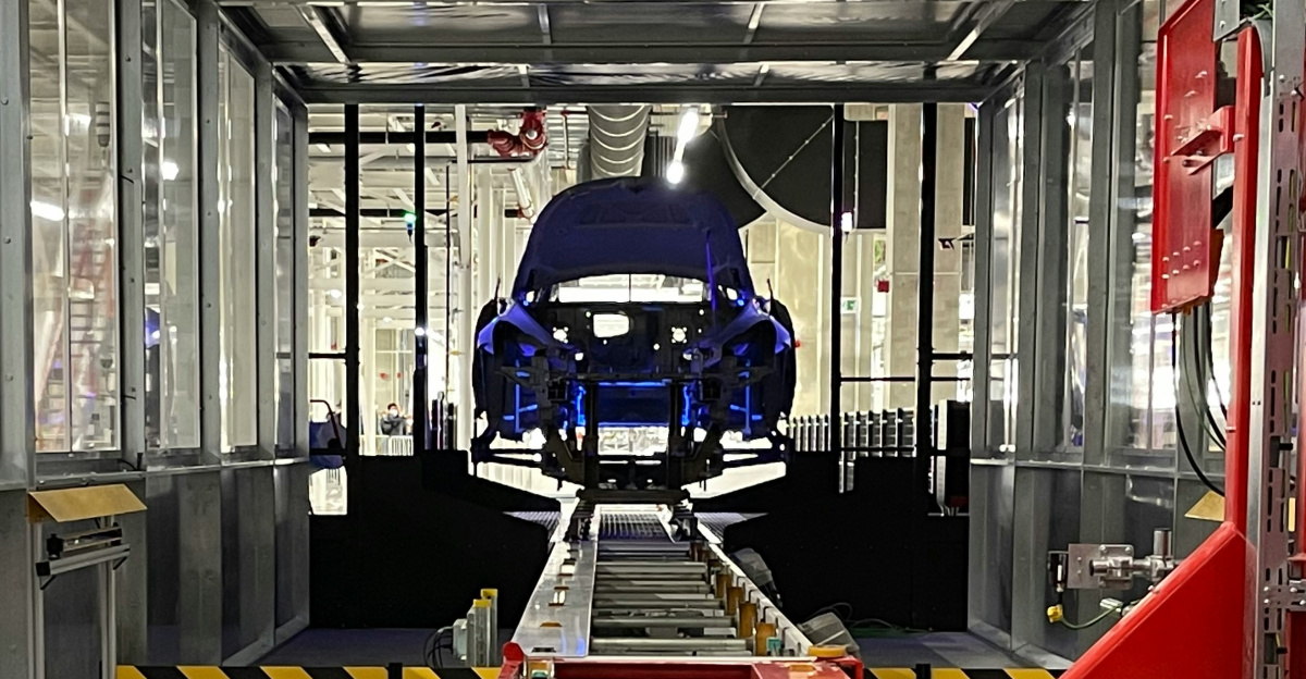 a car being built in a large factory