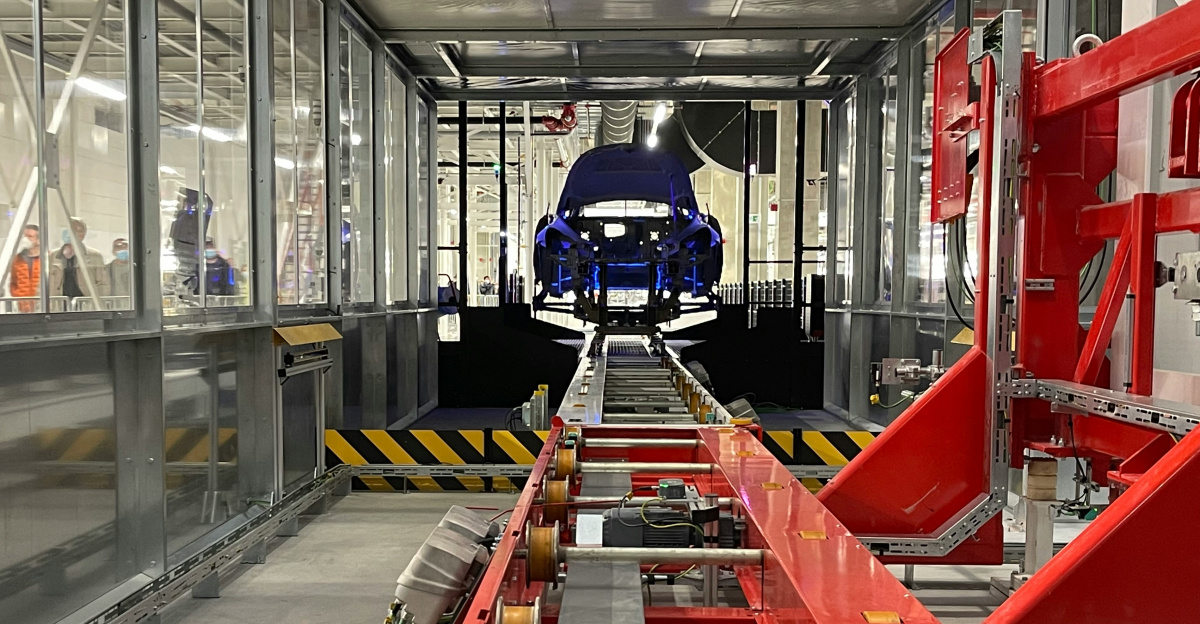 a car being built in a large factory