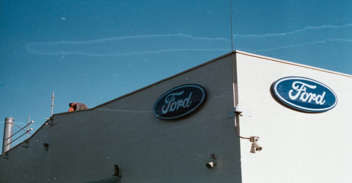 a ford dealership with a blue sky in the background