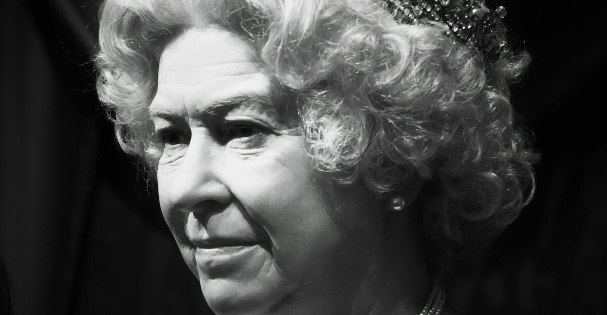 a black and white photo of a woman wearing a tiara