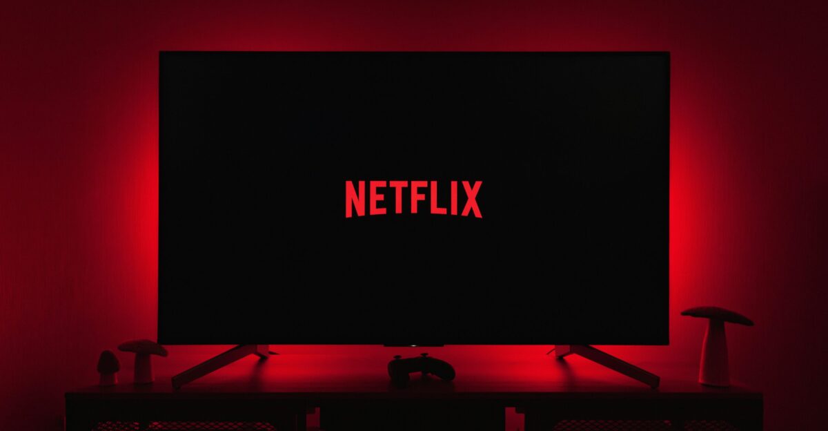 a television with the netflix logo lit up in the dark