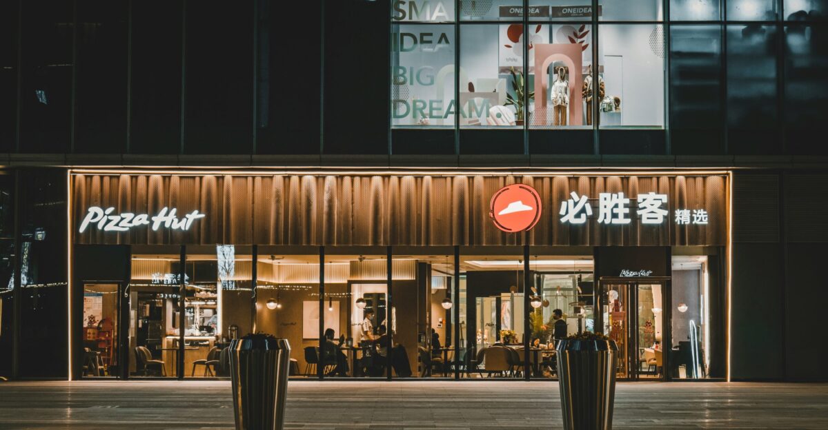 a building with a pizza hut lit up at night