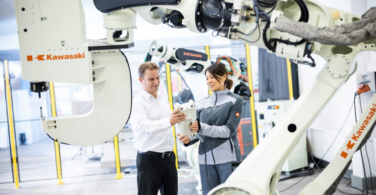 a man and a woman standing in front of a robot