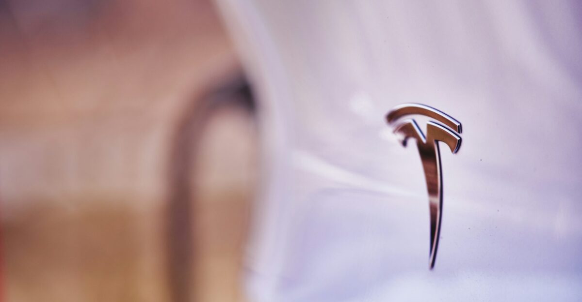 a close up of a car emblem on a white car