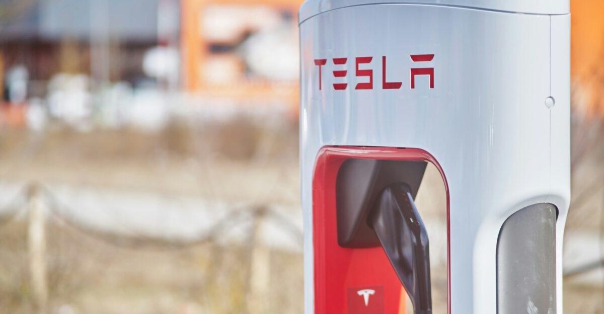a close up of a red and white tesla charging station