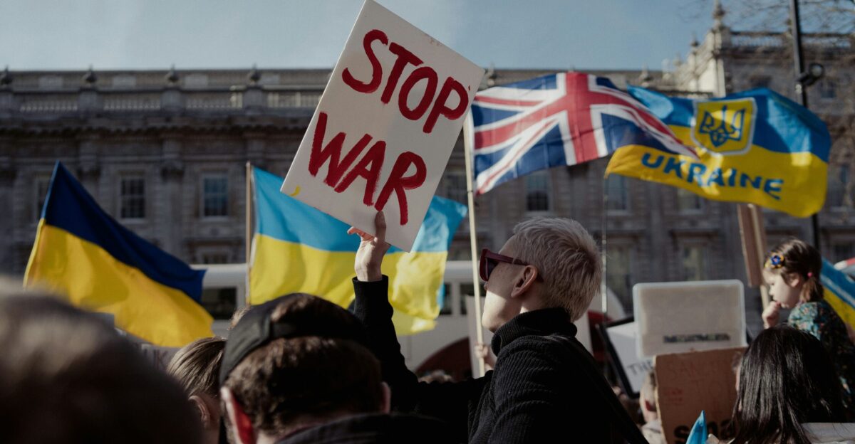 a group of people holding up signs and flags