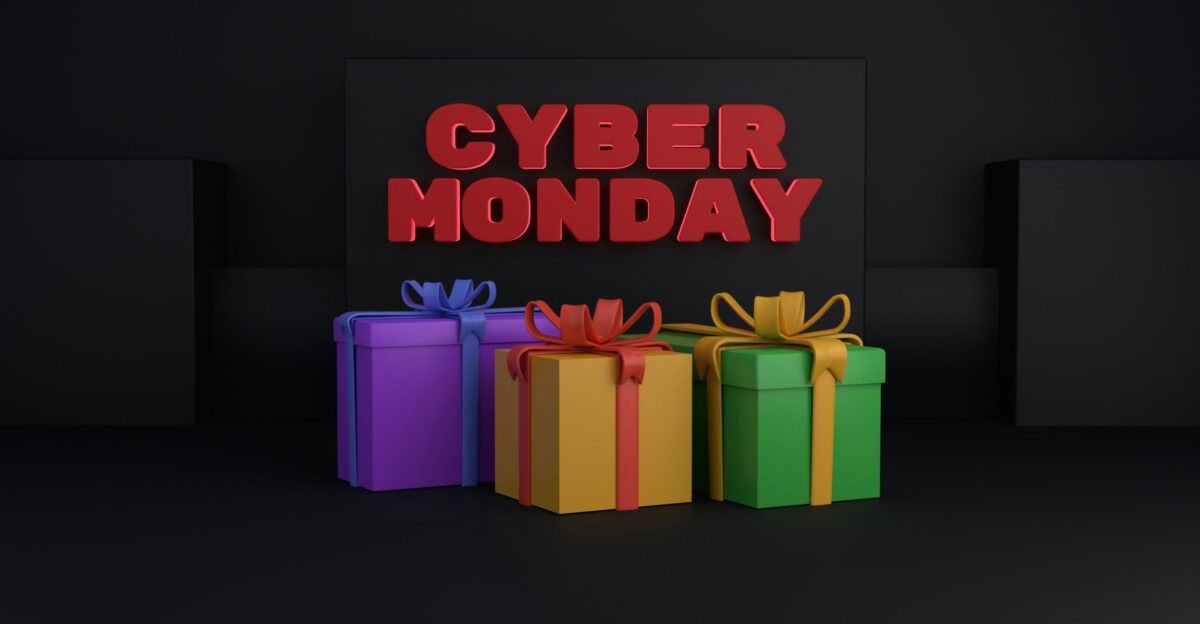 a sign that says cyber monday next to three wrapped presents
