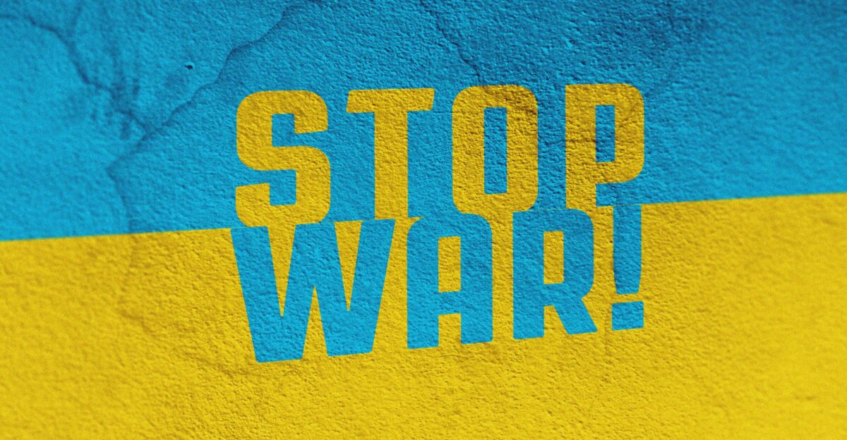 a blue and yellow wall with the words stop war painted on it