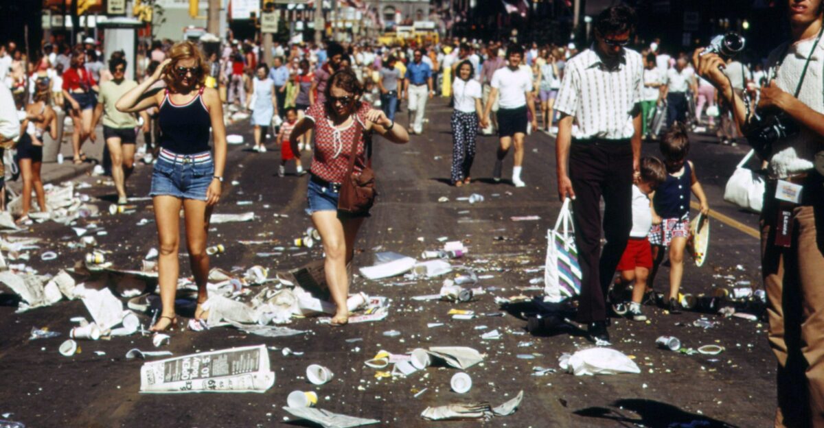 a large group of people walking down a street