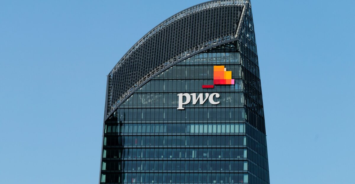 a tall building with a pwc logo on top of it
