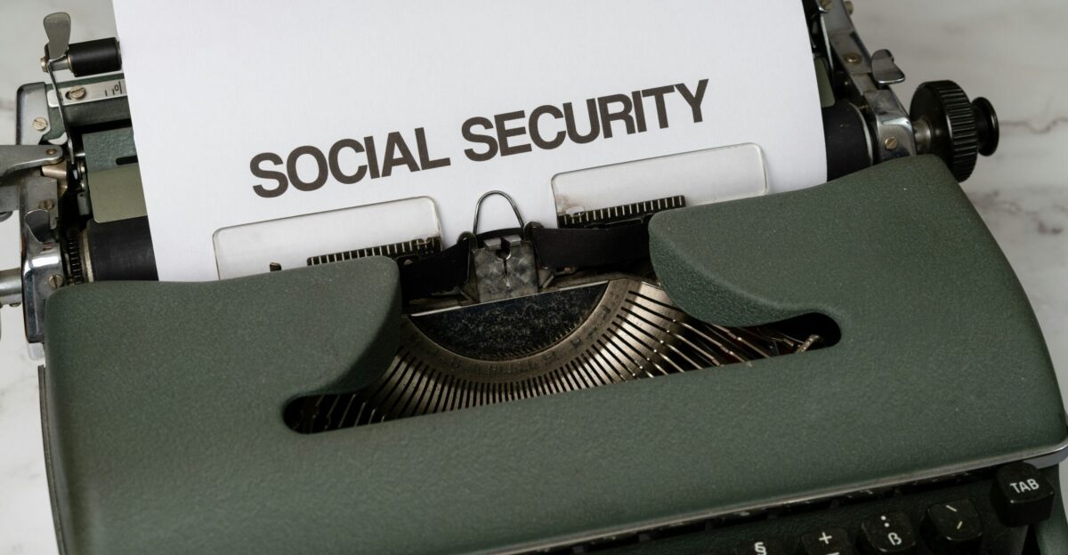 a close up of a typewriter with a paper that says social security