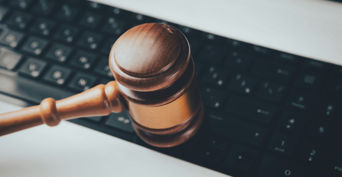 a wooden gaven sitting on top of a computer keyboard
