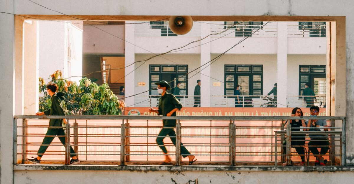 A group of people walking across a bridge