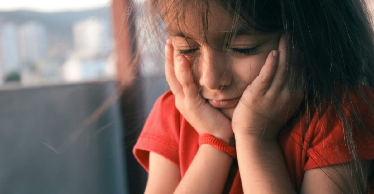 a person covering the face with the hands