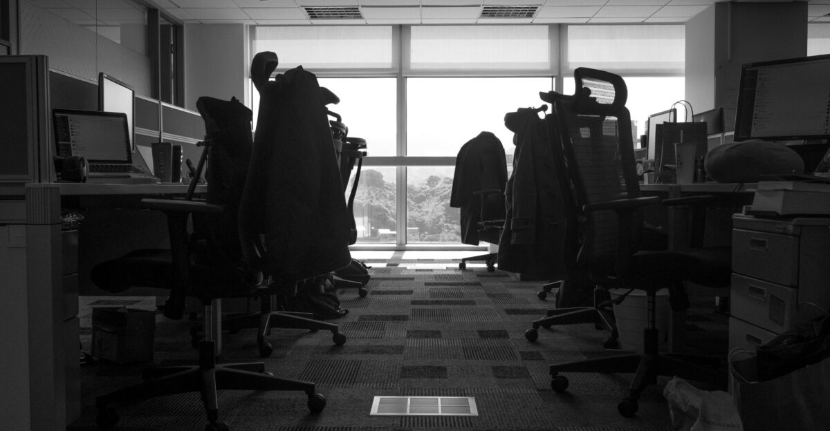 a room with a desk and chairs