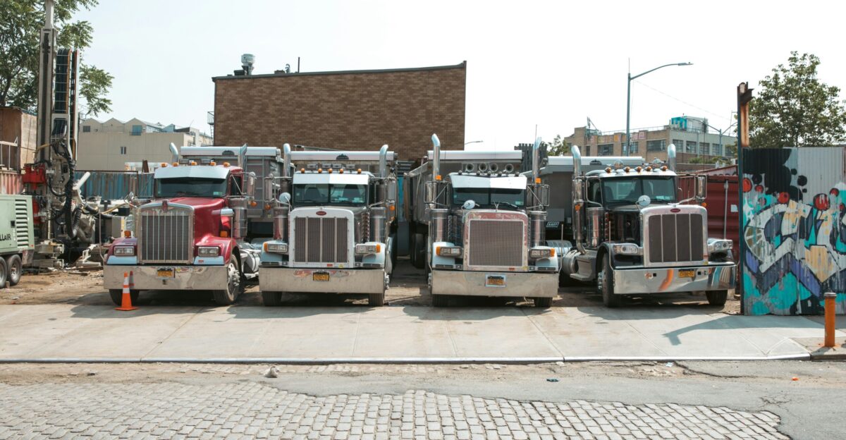 a group of trucks parked on the side of a road