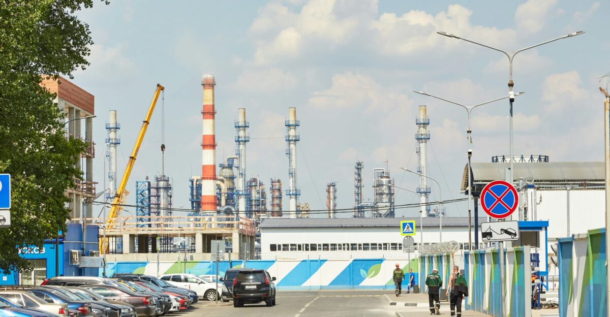 a road with cars and a building with a tower in the background