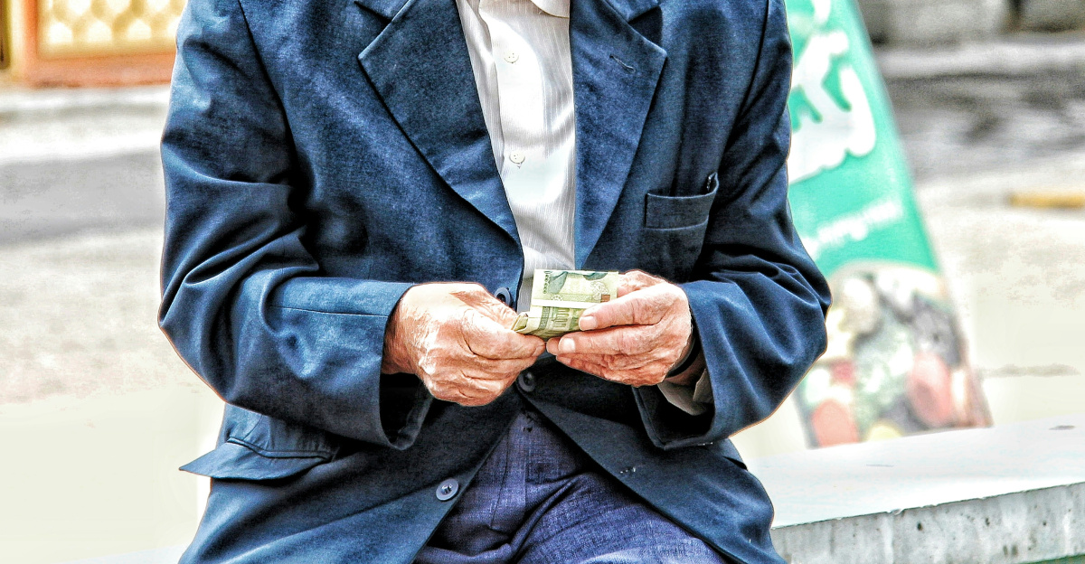 a man in a hat holding a glass of beer
