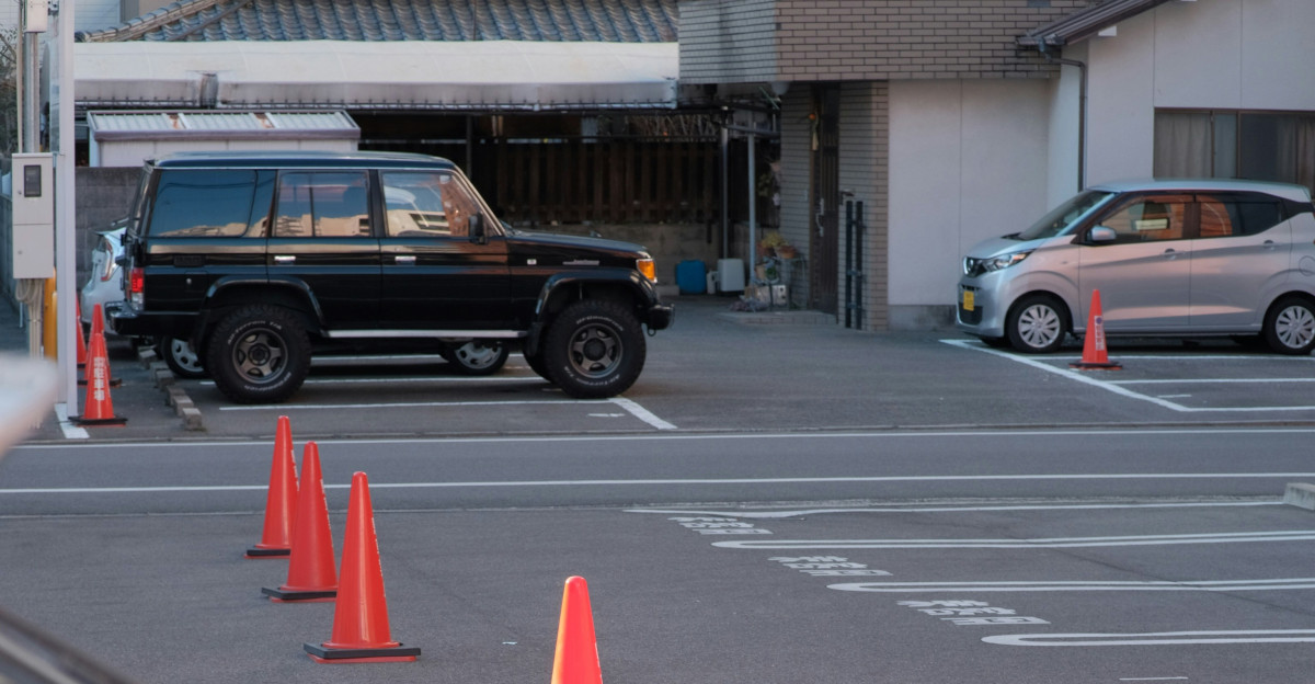 a car parked in a parking lot next to orange cones