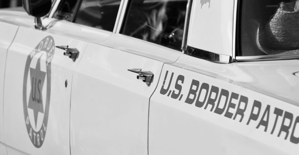 a black and white photo of a u s border patrol car