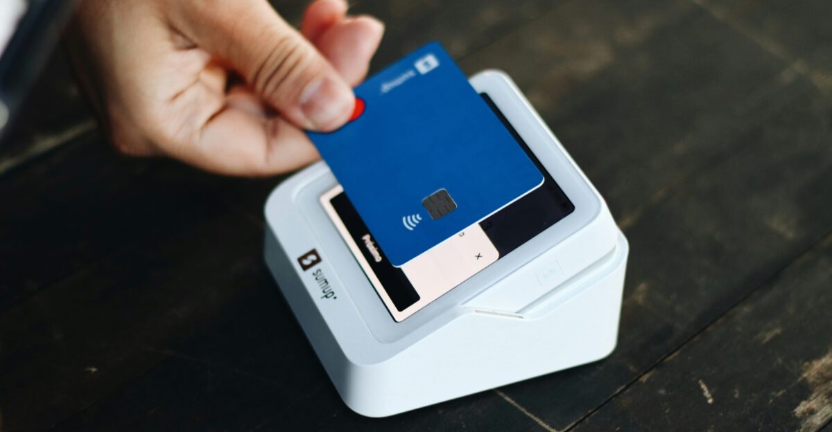 a person holding a credit card in their hand