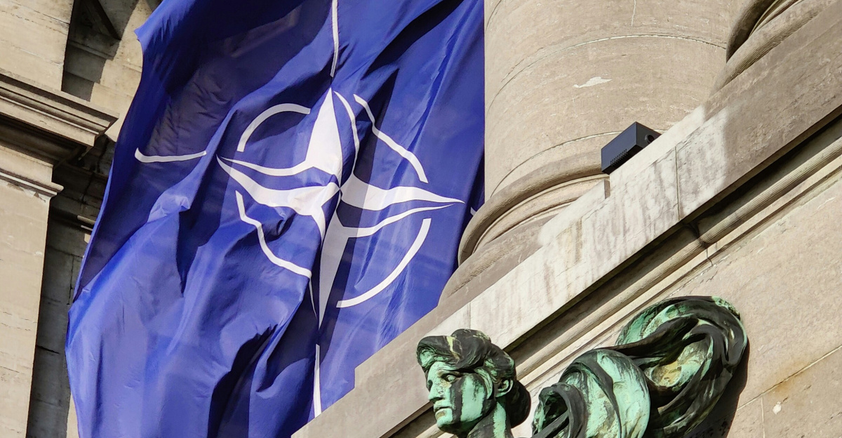 a statue of a man holding a flag in front of a building