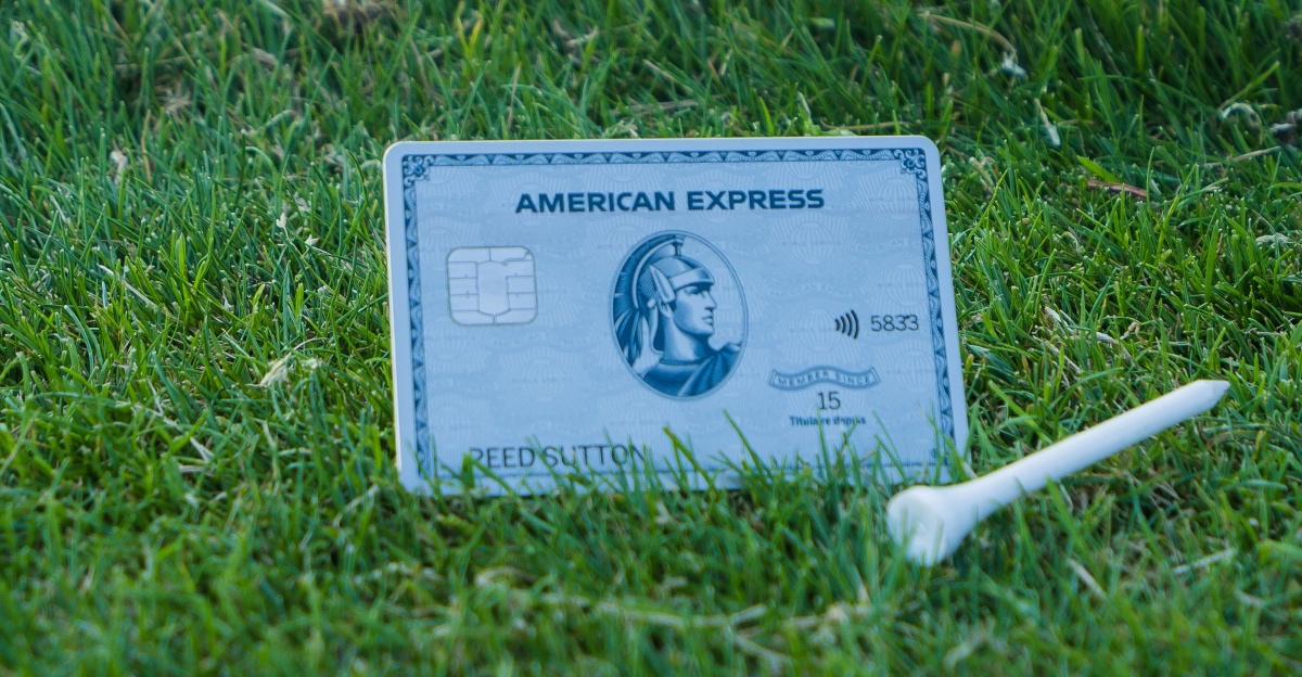 a business card laying on the ground in the grass