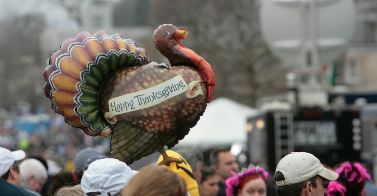a large turkey balloon with a turkey on top of it