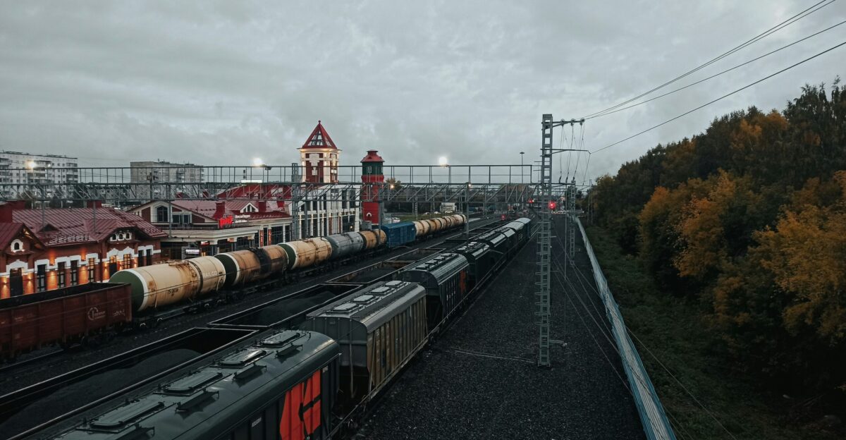 a train yard with several trains on the tracks
