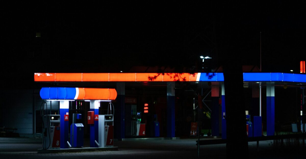 a gas station lit up at night time