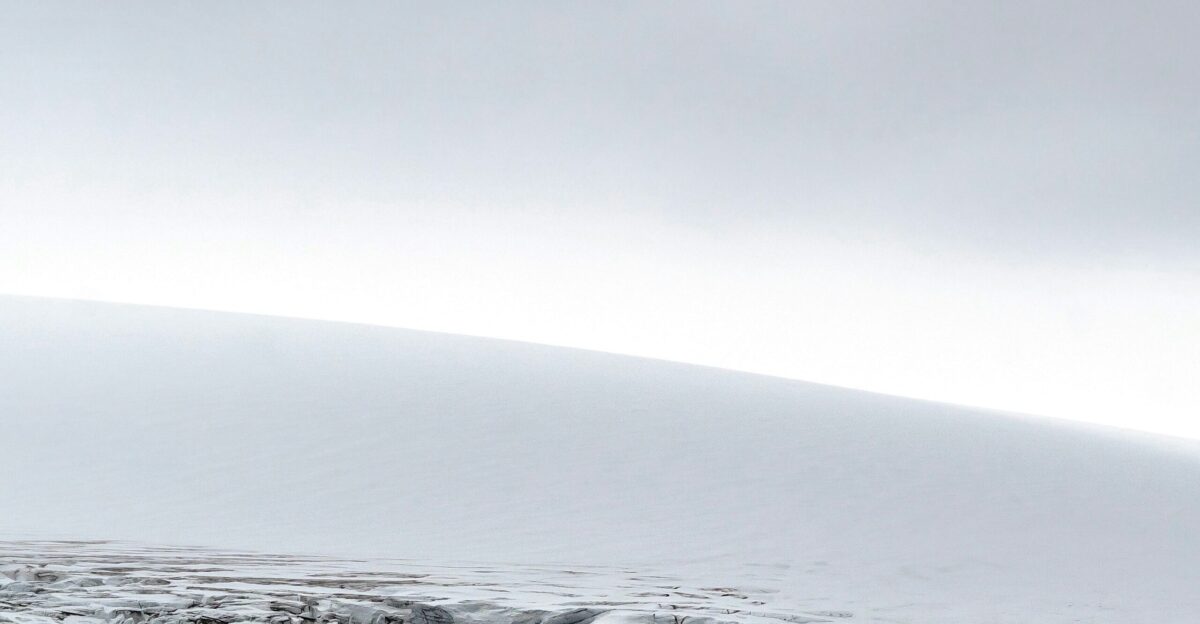 a man riding skis down a snow covered slope