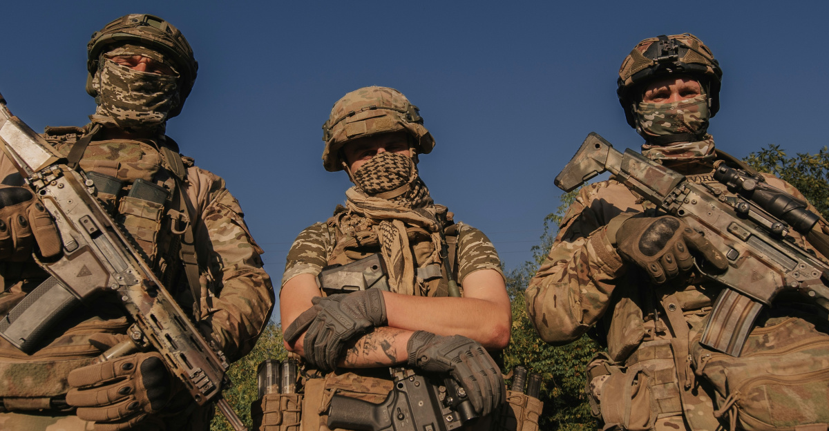 a group of men in camouflage holding guns