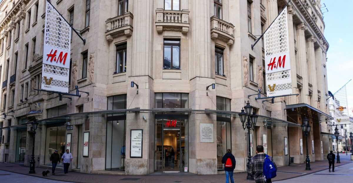 a couple of people that are standing in front of a building