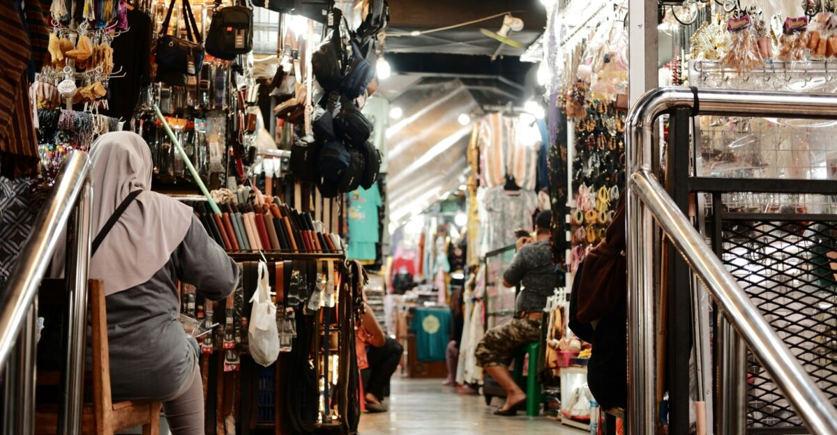 a woman is walking up a set of stairs in a store