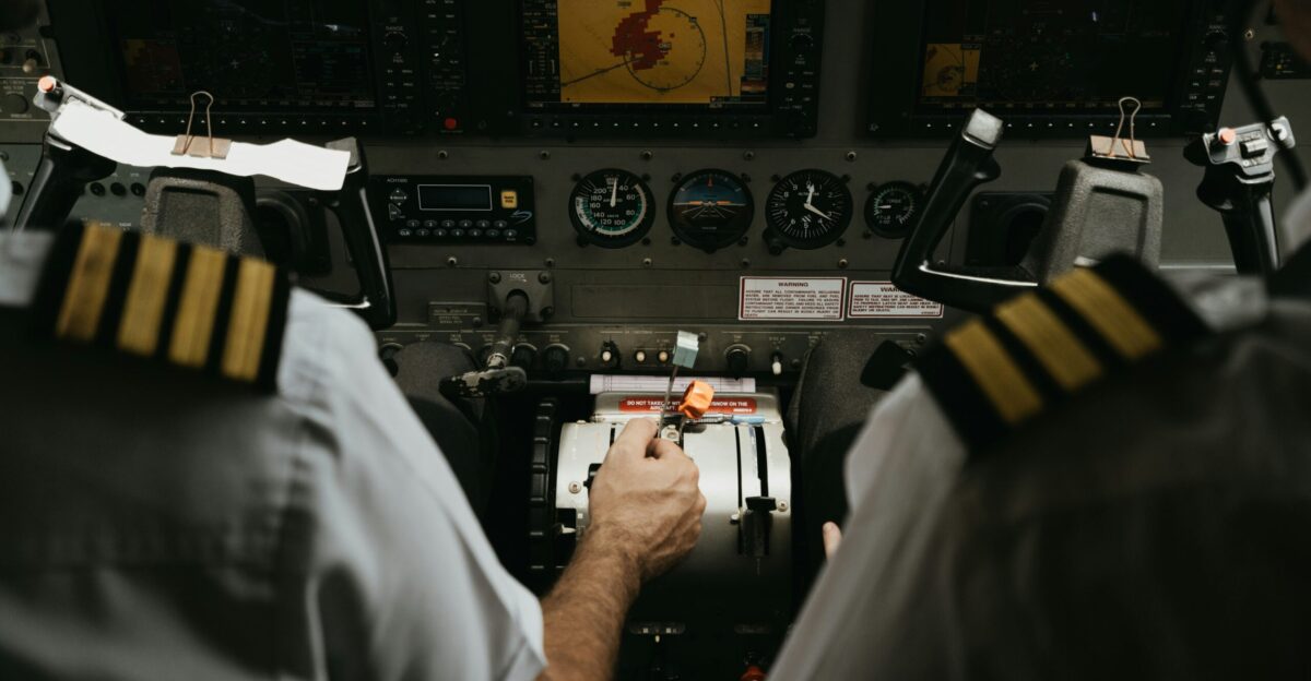 two pilots in the cockpit of a plane