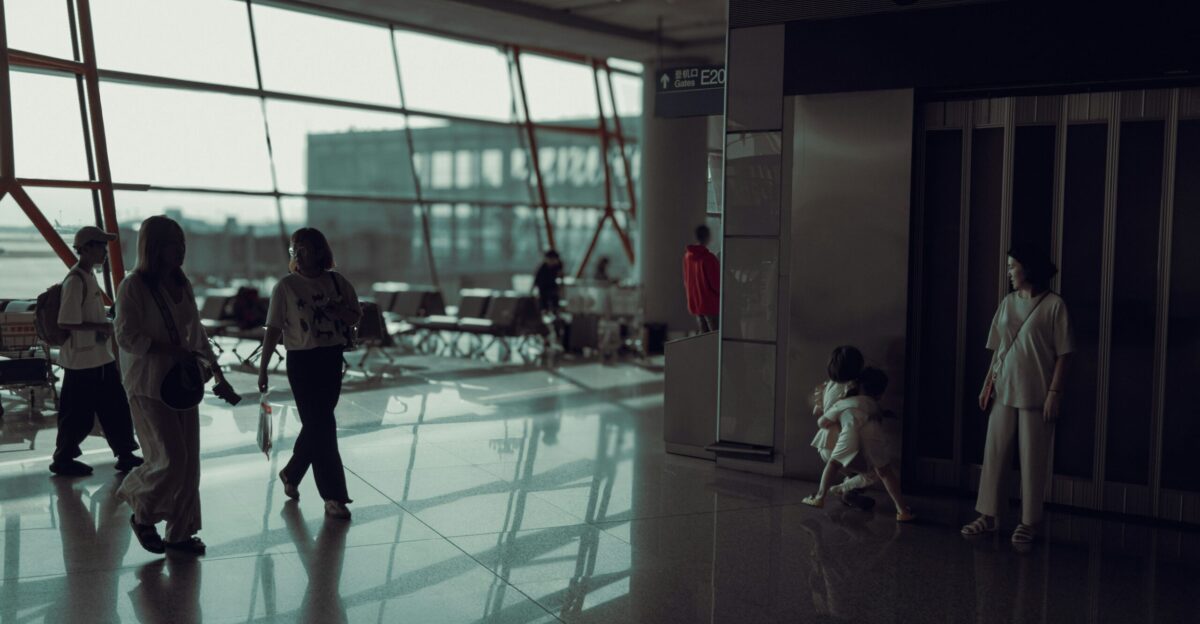 A group of people walking through an airport
