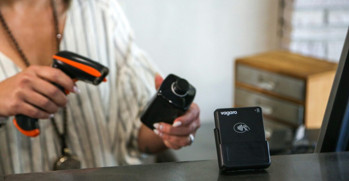 A woman wearing a face mask holding two cameras