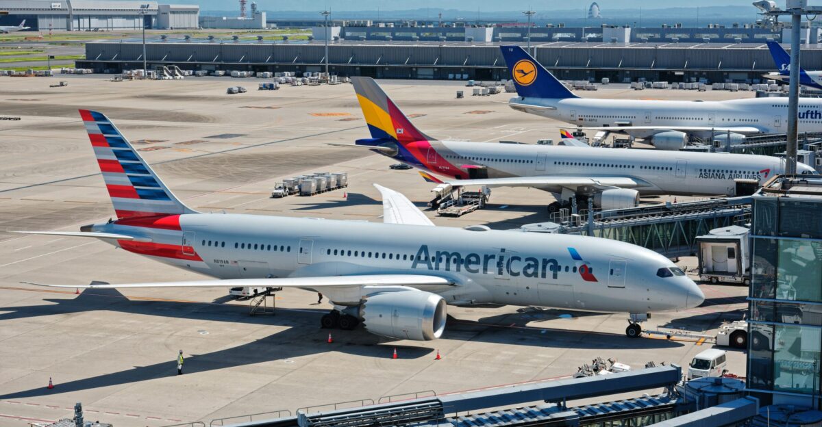 A bunch of airplanes that are on a runway