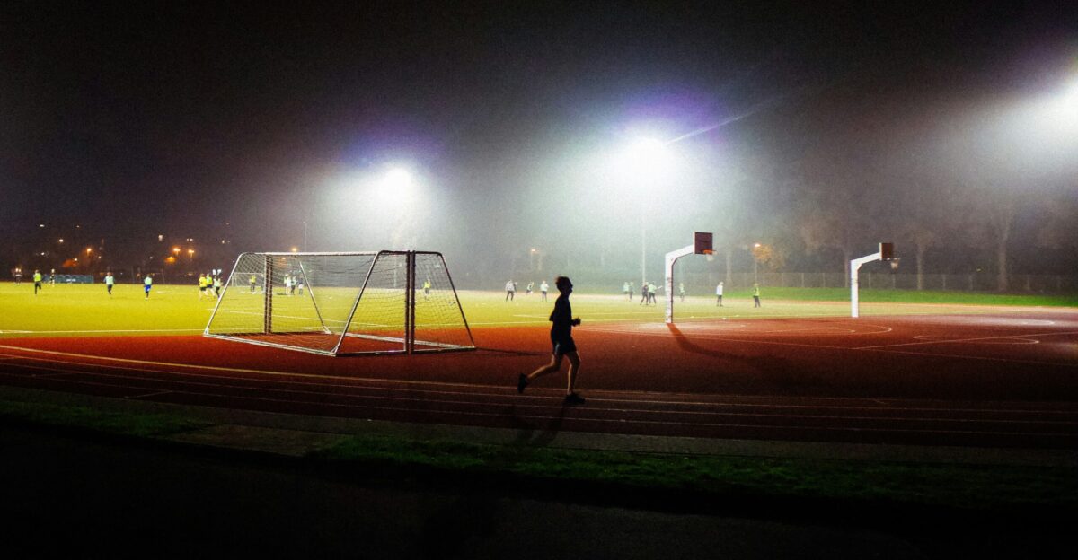 A person running on a track at night