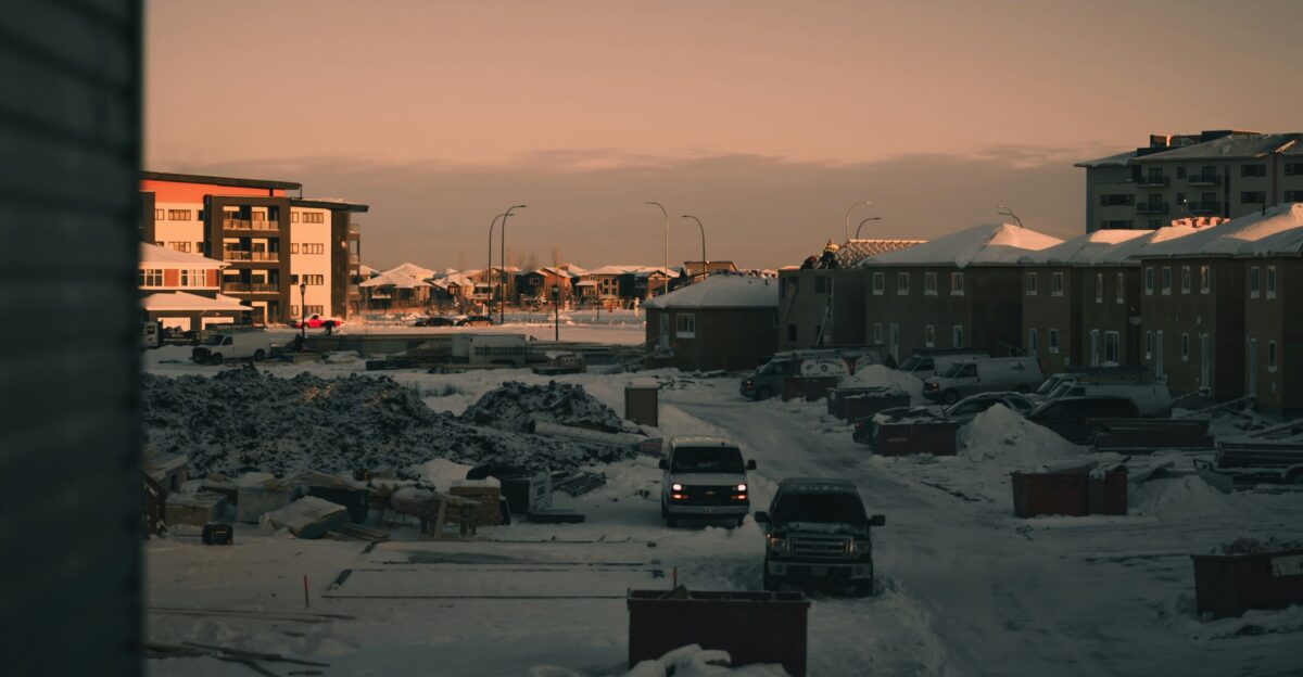 A city street covered in snow next to tall buildings