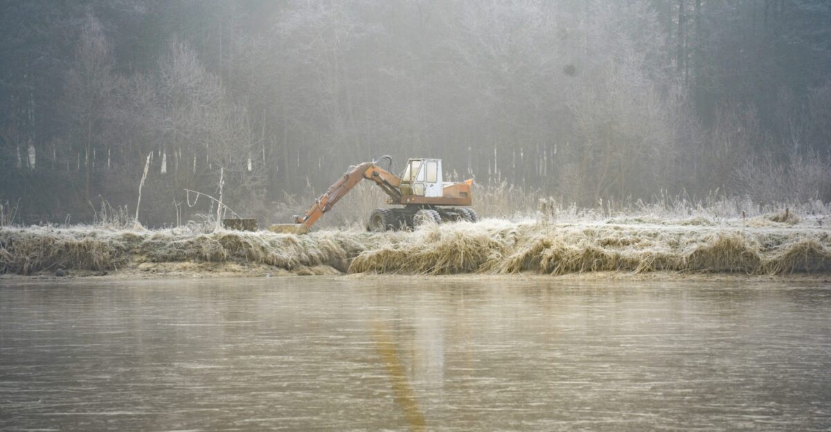 A truck is driving through a flooded area